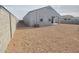 Backyard featuring gravel landscaping, an A/C unit, and a covered patio, creating a low-maintenance outdoor space at 2994 N 305Th Dr, Buckeye, AZ 85396