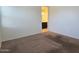 Inviting bedroom featuring neutral walls and carpet, with a glimpse into the bathroom at 2994 N 305Th Dr, Buckeye, AZ 85396