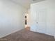 Spacious bedroom with plush carpet and a view into the home's other rooms at 2994 N 305Th Dr, Buckeye, AZ 85396