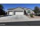 Charming single-story home featuring a gray stucco exterior, a two-car garage, and low maintenance landscaping at 2994 N 305Th Dr, Buckeye, AZ 85396