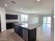 Modern kitchen featuring granite countertops, stainless steel appliances, and an island with dishwasher at 2994 N 305Th Dr, Buckeye, AZ 85396