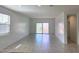 Bright living room featuring tile flooring and a sliding glass door leading to the backyard at 2994 N 305Th Dr, Buckeye, AZ 85396