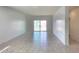 Bright living room featuring tile flooring and a sliding glass door leading to the backyard at 2994 N 305Th Dr, Buckeye, AZ 85396