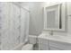 Bathroom featuring a tub and shower with marble patterned curtains and white vanity at 3002 W Josiah Trl, Queen Creek, AZ 85144