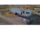 Gorgeous view of the house featuring gray paint, rock, and a spacious driveway at 3002 W Josiah Trl, Queen Creek, AZ 85144