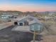 Charming gray single-story home with a desert landscape and a three-car garage at 3002 W Josiah Trl, Queen Creek, AZ 85144