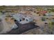 Home's exterior shown with desert landscape, fencing, and a trampoline in the yard at 3002 W Josiah Trl, Queen Creek, AZ 85144