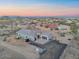 Aerial view of a gray single-story home in a desert landscape with a three-car garage at 3002 W Josiah Trl, Queen Creek, AZ 85144