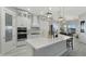 Bright modern kitchen with white cabinets, stainless appliances, and a stylish range hood at 3002 W Josiah Trl, Queen Creek, AZ 85144