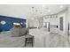 Open concept kitchen with white cabinetry, quartz countertops, and an island with bar seating at 3002 W Josiah Trl, Queen Creek, AZ 85144