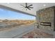 Outdoor living area with stone fireplace and expansive desert views at 3002 W Josiah Trl, Queen Creek, AZ 85144