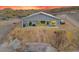 View of the home exterior at dusk, featuring a covered patio and desert landscape, with a great sunset at 3002 W Josiah Trl, Queen Creek, AZ 85144