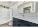 Bright bathroom featuring modern vanity, large mirror, and shower with white tile surround at 3104 E Broadway Rd # 276, Mesa, AZ 85204