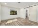 Bright, spacious bedroom featuring modern flooring, a large window and sliding barn door at 3104 E Broadway Rd # 276, Mesa, AZ 85204