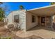 Exterior view of the home showcasing a covered patio and well-maintained yard at 3104 E Broadway Rd # 276, Mesa, AZ 85204