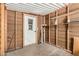 Unfinished storage space with raw wooden walls, shelving, and an exterior door at 3104 E Broadway Rd # 276, Mesa, AZ 85204