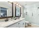 Luxurious bathroom with dual sinks, marble countertops, and a frameless glass shower at 4381 N 86Th St, Scottsdale, AZ 85251