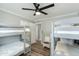 Bright bedroom with gray bunk beds, ceiling fan, and a white wicker chair at 4381 N 86Th St, Scottsdale, AZ 85251