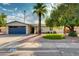 Lovely home featuring a palm tree, two-car garage, and a beautifully landscaped front yard at 4381 N 86Th St, Scottsdale, AZ 85251