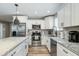 Modern kitchen with stainless steel appliances, white cabinets, and stone countertops at 4381 N 86Th St, Scottsdale, AZ 85251