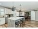 Well-lit kitchen features stainless appliances, island with stools, and a view to dining space at 4381 N 86Th St, Scottsdale, AZ 85251