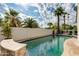 Serene pool with lush palm trees, a privacy wall, and comfortable lounge chairs at 4381 N 86Th St, Scottsdale, AZ 85251