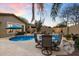 Relaxing backyard pool area with dining set, desert landscaping, and desert sunset at 4411 E Spur Dr, Cave Creek, AZ 85331