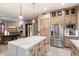 Stylish kitchen featuring wood cabinets, stainless steel appliances, and an open connection to the living area at 4411 E Spur Dr, Cave Creek, AZ 85331