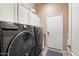 Modern laundry room featuring new front load washer and dryer at 4411 E Spur Dr, Cave Creek, AZ 85331