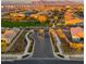 Elevated neighborhood view with gated entrance, lush landscaping, and mountain backdrop at 4462 S Frequency Dr, Mesa, AZ 85212