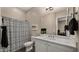 Bathroom features a modern vanity with a white countertop, decorative shower curtain, and neutral tones at 4462 S Frequency Dr, Mesa, AZ 85212