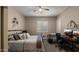 Well-lit bedroom with a ceiling fan, plantation shutters, a comfortable bed, and a dedicated desk area at 4462 S Frequency Dr, Mesa, AZ 85212