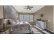 Inviting bedroom featuring neutral colors, ceiling fan, and plantation shutters for natural light at 4462 S Frequency Dr, Mesa, AZ 85212