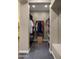 Well-lit walk-in closet with custom shelving, clothes hanging, and carpeted flooring at 4462 S Frequency Dr, Mesa, AZ 85212