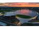 Aerial view of a community lake with walking paths, a pavilion, and scenic landscaping at sunset at 4462 S Frequency Dr, Mesa, AZ 85212