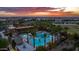 Aerial view of a community pool surrounded by palm trees, seating, and well-maintained landscaping at 4462 S Frequency Dr, Mesa, AZ 85212