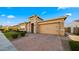 Inviting single-story home with stone veneer accents, desert landscaping, and a brick paver driveway at 4462 S Frequency Dr, Mesa, AZ 85212