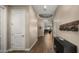 Long hallway featuring wood floors and decorated with modern fixtures leading to a living room at 4462 S Frequency Dr, Mesa, AZ 85212