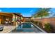 Gorgeous backyard pool with stone accents, covered lounge, and mature landscaping at 4462 S Frequency Dr, Mesa, AZ 85212