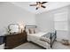 Bright bedroom with a metal bed frame, a wooden dresser, and a window at 4595 W Stonecrop Dr, San Tan Valley, AZ 85144