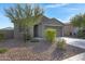 Charming single-story home featuring a well-manicured front yard with desert landscaping and a two-car garage at 4595 W Stonecrop Dr, San Tan Valley, AZ 85144