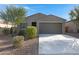 Charming single-story home featuring a well-manicured front yard with desert landscaping and a two-car garage at 4595 W Stonecrop Dr, San Tan Valley, AZ 85144