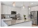 Bright kitchen featuring white cabinetry, stainless appliances, and a large center island at 4595 W Stonecrop Dr, San Tan Valley, AZ 85144