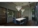 Luxurious dining room with chic light fixtures, marble fireplace and convenient wine storage at 6001 N 37Th Pl, Paradise Valley, AZ 85253