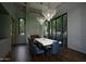 Sophisticated dining room featuring stunning chandeliers, fireplace, and wine storage at 6001 N 37Th Pl, Paradise Valley, AZ 85253