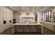 Bright kitchen boasts modern design, center island and stylish pendant lighting at 6001 N 37Th Pl, Paradise Valley, AZ 85253