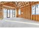 Unfinished living room featuring wood framing, large windows, and sliding doors, revealing the underlying structure at 6001 N 37Th Pl, Paradise Valley, AZ 85253