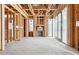 Unfinished living room with concrete floor, wooden framing, and natural light, showing construction at 6001 N 37Th Pl, Paradise Valley, AZ 85253