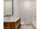 Bathroom featuring wood vanity with white countertop and toilet with tiled shower in the background at 7047 E Earll Dr # 1002, Scottsdale, AZ 85251