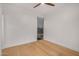 Sun-filled bedroom with light wood flooring, ceiling fan, white walls, and modern window at 7047 E Earll Dr # 1002, Scottsdale, AZ 85251